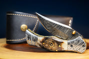 🐏 RAM HORNS IN THE WILD: Damascus Steel EDC Pocket Folding Knife With Leather Sheath by SacredBlade