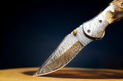 🐏 RAM HORNS IN THE WILD: Damascus Steel EDC Pocket Folding Knife With Leather Sheath by SacredBlade